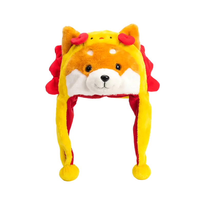Keltainen shiba punaisen harjan pehmohattulla